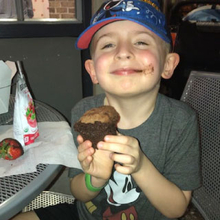 boy GI patient eating gluten free cupcake