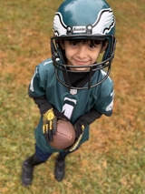 Jayant in Philadelphia Eagles green jersey and helmet