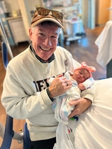 The grandfather is happy.