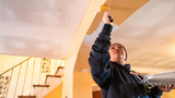 Worker painting ceiling