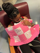 premature baby being held by mom
