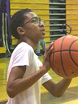 Jayden shooting a basketball
