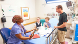 Anesthesia pre-op exam room with family