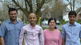Arnav with his family outside on crutches