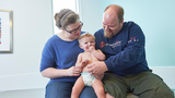 Baby Emmett with his parents at CHOP smiling