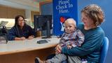 Mom and toddler son at the check-in desk