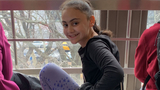 female patient with turner's syndrome sitting in front of window smiling