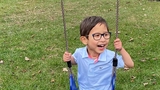 Olly riding a swing