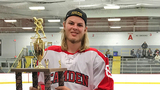 Jared holding his hockey trophy
