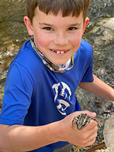 Maxwell holding a lizard in his hand