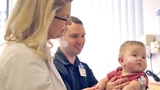 Dr. Hedrick holding a young patient
