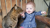 Paisley sitting with her cat