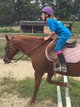 Laura riding a horse