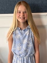 Peyton smiling with a floral dress