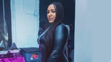 Dominique standing wearing a black dress