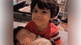 Isaac holding Levi