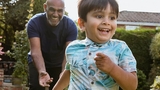Chasing grandson in the garden during outdoors playtime. Chasing grandson in the garden during outdoors playtime.