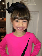 Ella IBD patient smiling wearing a gymnastics leotard