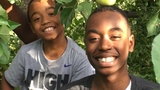 Emerson and Kenny outside under apple tree