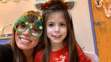 girl and mom smiling christmas costumes