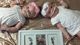 Erin and Abby separated with their foot and handprints framed below them