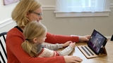 Mom and daughter looking at mobile tablet