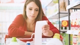 upset woman holding grocery receipt upset woman holding grocery receipt