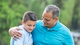 Father with arm around son