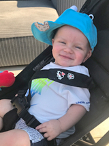 Harry sitting in his stroller