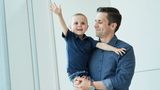 Young boy cancer patient being held by his dad