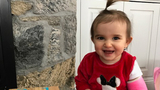 Kaylee smiling sitting on porch