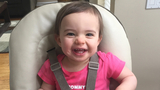 Lilly sitting in highchair and smiling