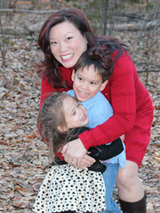 Mariella with her mother and brother outside