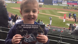 Cardiac patient at baseball game holding up program