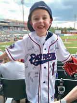 Cardiac patient in baseball jersey at baseball game