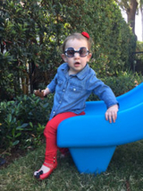 Milana going down slide after CDH surgery