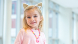 Nadia smiling wearing cat ears