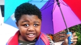 Matthew holding an umbrella