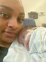 Mother holding newborn daughter