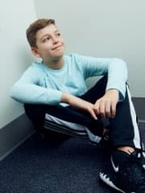 Allergy patient sitting on the floor smiling