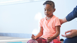 Quinn participating in yoga therapy meditation