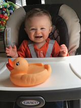 Roman sitting in high chair