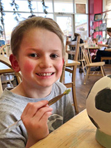 Liam painting a soccer ball