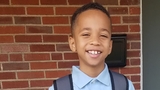 Samad on front porch in school uniform