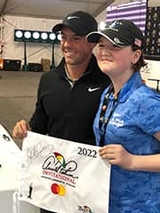 Sophia with a golf pro