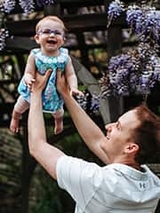 Elizabeth being held up by her dad