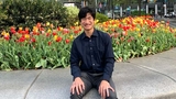 Dan sitting in front of flowers