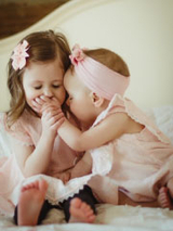 baby and toddler sister laughing