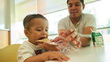 Osiel Bravo helps his son Sebastian