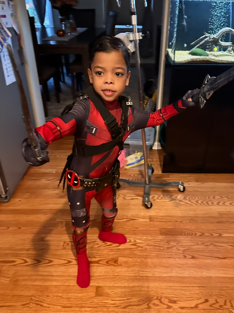 Asher, now 5, in a red and black Halloween costume